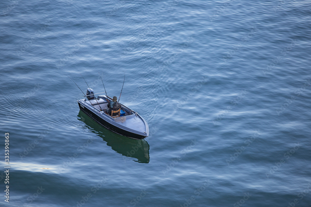 Naklejka premium Venice, Italy - angler in the boat in the morning