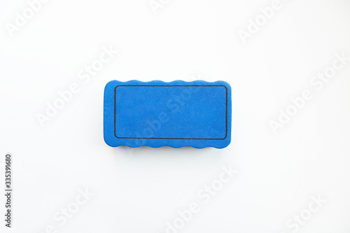 Blue sponge on a white background in the center.
