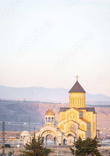 View from distance to new New Makhata Iveron Icon of the Mother of God church in Tbilisi with mountains in the background. Georgia.Churches in Caucasus 2020.