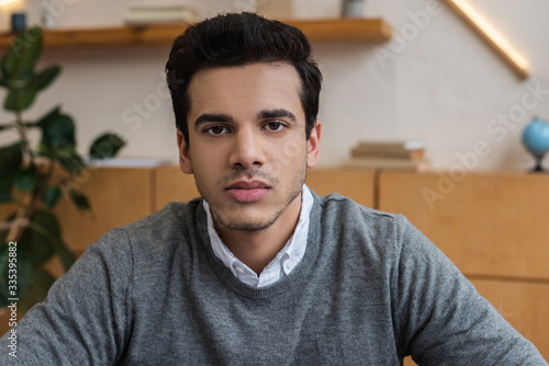 Portrait of businessman looking at camera in office