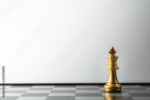 lonely golden king chess standing on chess board.