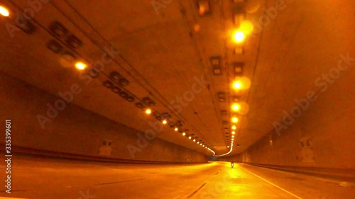 Car driving through the steep tunnels of San Francisco city. View from the car.