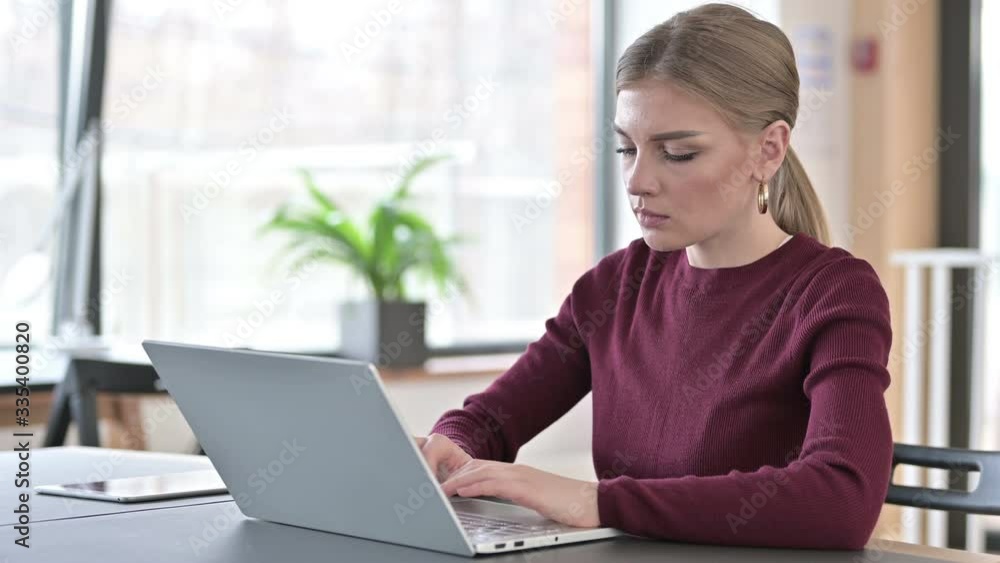 Professional Young Woman using Laptop in Office Professional Young Woman using Laptop in Office