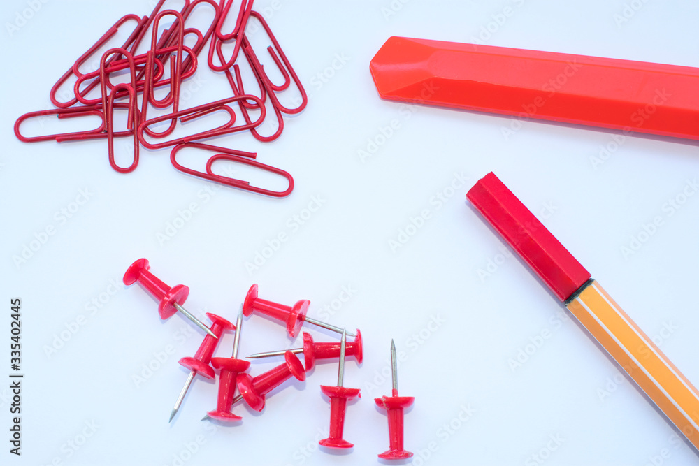 Office supplies in red on a white background, plain photo with free space for text Office supplies in red on a white background, plain photo with free space for text
