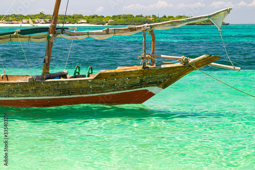 Colorful african wooden boat in ocean. Zanzibar coast. Africa