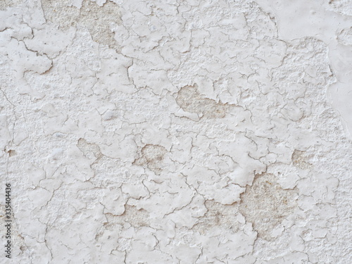 Ditry white old painted wall peeling off cause by low quality paint that has inadequate adhesion and flexibility,Over thinning the paint or spreading it too thin. Poor adhesion of the underlying coats