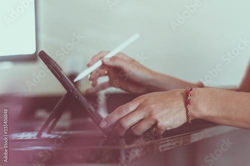 Artist is working at home with tablet. Artist's hands.