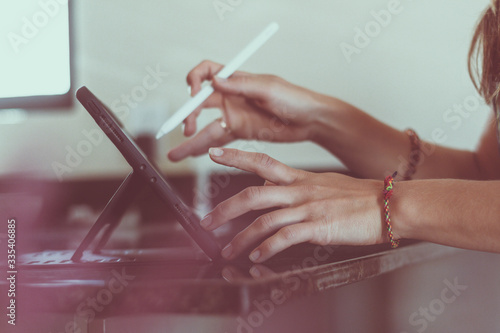 Artist is working at home with tablet. Artist's hands.