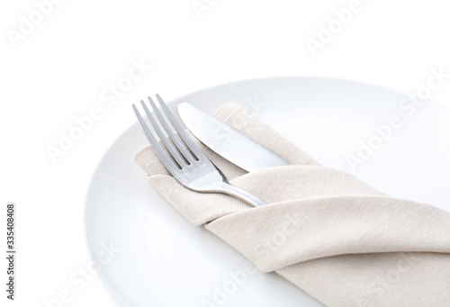 Stylish elegant cutlery with napkin in plate isolated on white