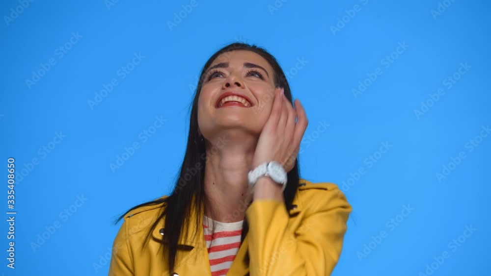 Beautiful woman laughing at camera isolated on blue Beautiful woman laughing at camera isolated on blue