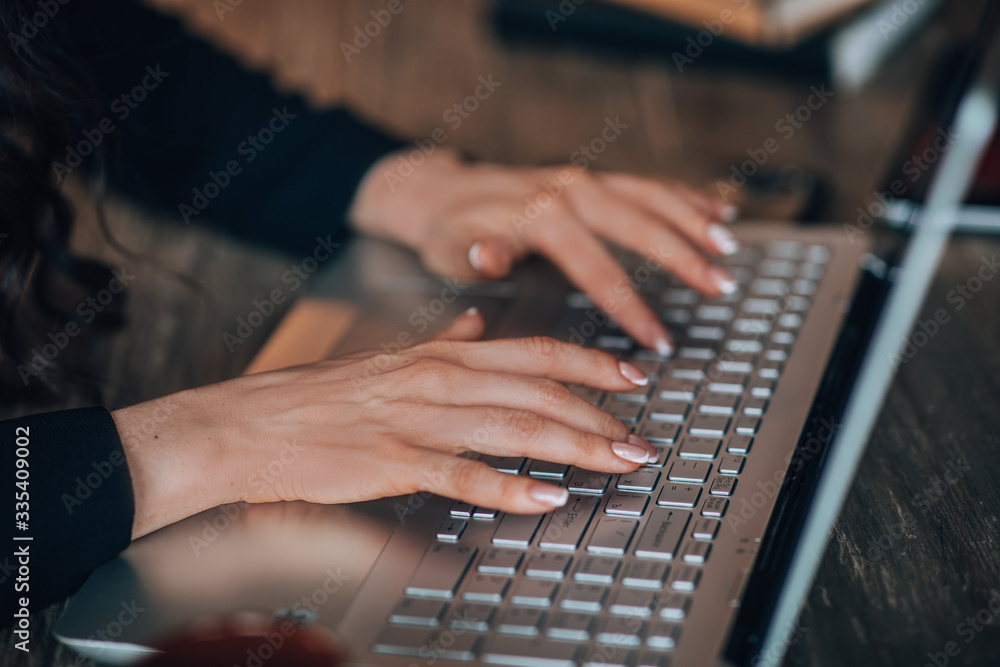 Close up of female hands while typing on laptop Close up of female hands while typing on laptop