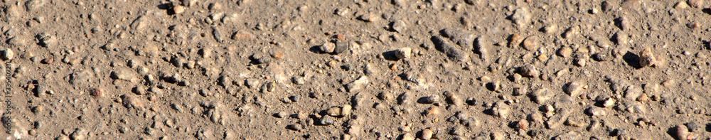 Background of asphalt on the screen saver. Texture of small stones, road surface. Background of asphalt on the screen saver. Texture of small stones, road surface.