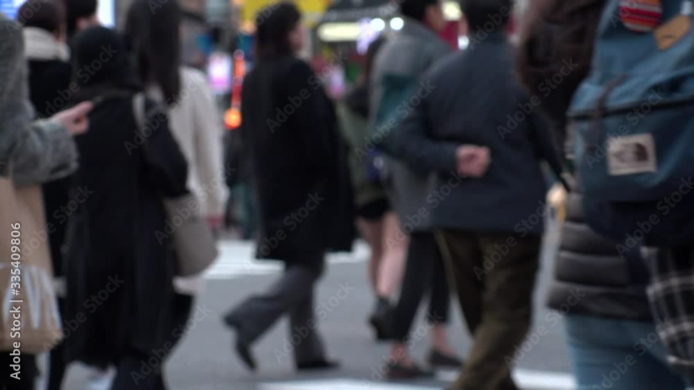 TOKYO, JAPAN -FEB 2020 : Crowd of people at Shibuya Scramble Crossing in busy weekend. Many pedestrians (Japanese people and tourist) at the street. Focus in front. Modern city lifestyle concept shot. TOKYO, JAPAN -FEB 2020 : Crowd of people at Shibuya Scramble Crossing in busy weekend. Many pedestrians (Japanese people and tourist) at the street. Focus in front. Modern city lifestyle concept shot.