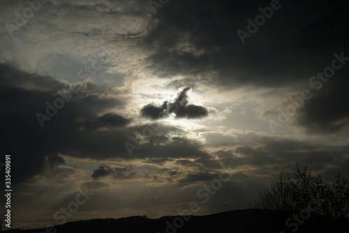 dramatic sky with sunlight and different kinds of clouds during the evening