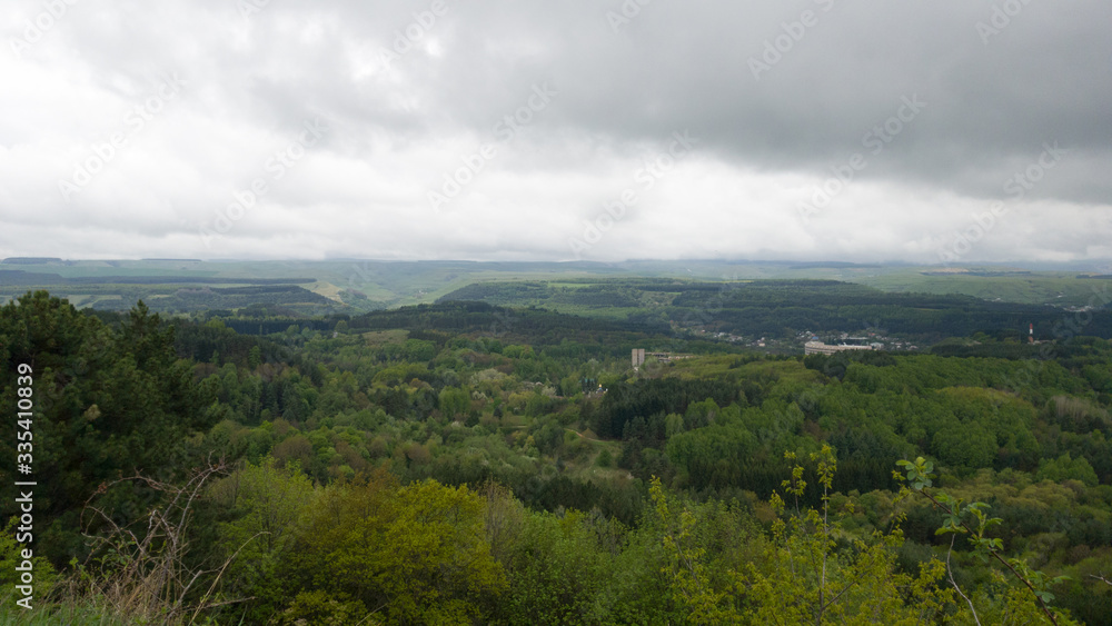 Cloudy panoramic view of the landscape of the Stavropol territory. View of fields, forests, city in the distance