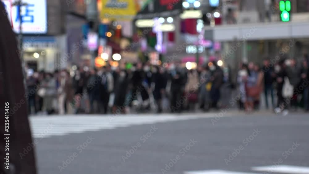 TOKYO, JAPAN -FEB 2020 : Crowd of people at Shibuya Scramble Crossing in busy weekend. Many pedestrians (Japanese people and tourist) at the street. Focus in front. Modern city lifestyle concept shot. TOKYO, JAPAN -FEB 2020 : Crowd of people at Shibuya Scramble Crossing in busy weekend. Many pedestrians (Japanese people and tourist) at the street. Focus in front. Modern city lifestyle concept shot.