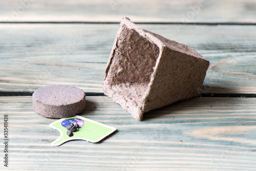 Peat pot, tablet from pressed earth and ipomoea seeds.