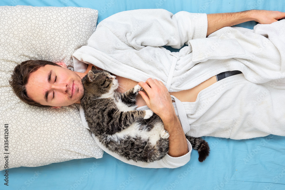 From above Man and cat sleeping together From above Man and cat sleeping together