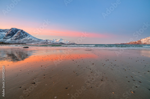 Amazing sunrise with amazing magenta color over sand beach. Tromso, Norway . Polar night. long shutter speed