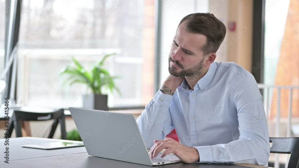 Hardworking Man having Neck Pain in Office Hardworking Man having Neck Pain in Office