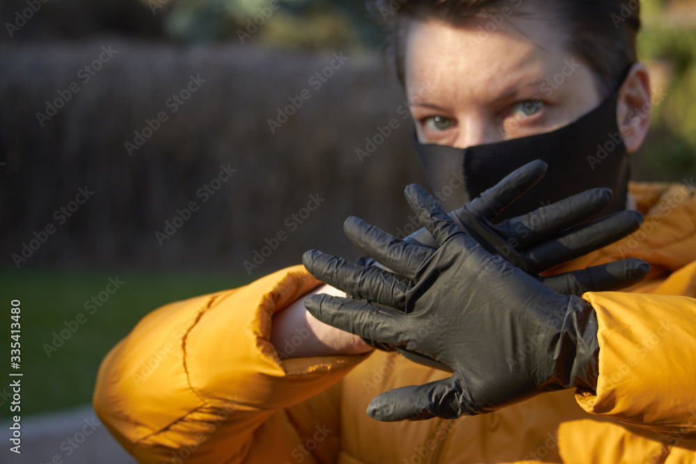Middle aged european woman in protective black mask makes an warning gesture during coronavirus COVID-19 Epidemic. Sick woman wearing protection during pandemic. Middle aged european woman in protective black mask makes an warning gesture during coronavirus COVID-19 Epidemic. Sick woman wearing protection during pandemic.