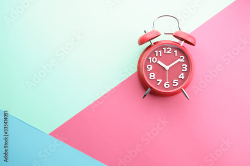 flat lay of alarm clock gainst color background. copy space for your text photo