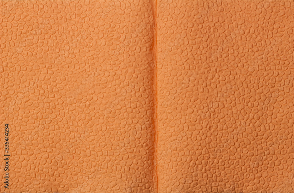 Fototapeta premium Background of an orange napkin in the form of an open book