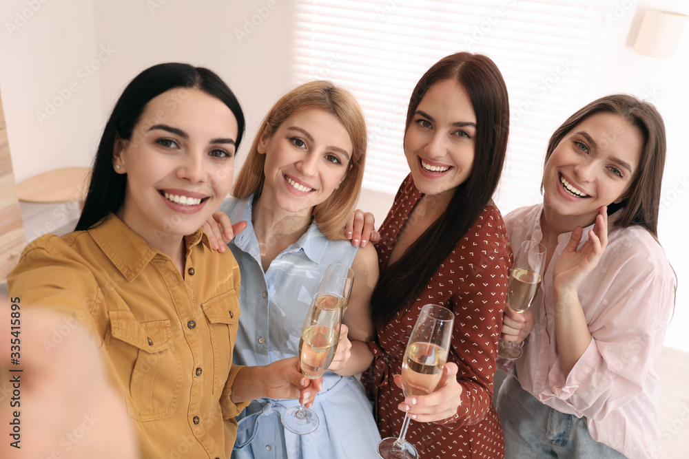 Beautiful young ladies with champagne taking selfie at home. Women's Day Beautiful young ladies with champagne taking selfie at home. Women's Day