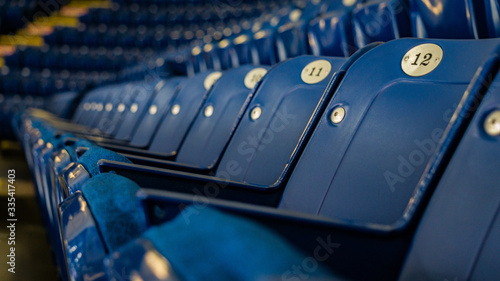Empty rows of blue stadium seats 