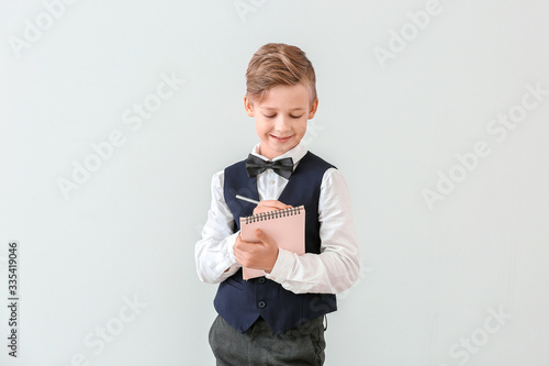 Cute little waiter with not...