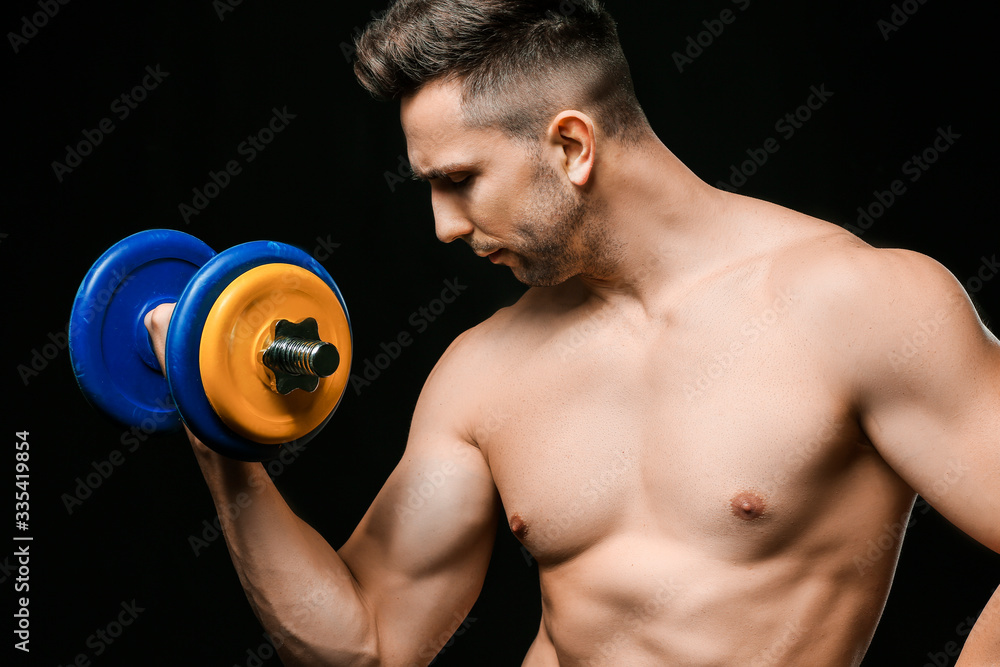 Sporty man with dumbbell on dark background Sporty man with dumbbell on dark background