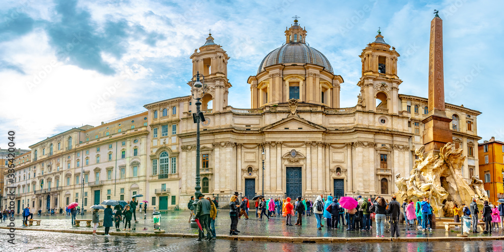 Obraz premium Rome, Italy. Sant Agnese in Agone baroque Church and Fountain of Four Rivers (Fontana Dei Quattre Fiumi) obelisk in Piazza Navona Square. Tourists visit ancient Roman architecture.