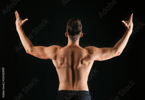 Sporty man on dark backgrou...