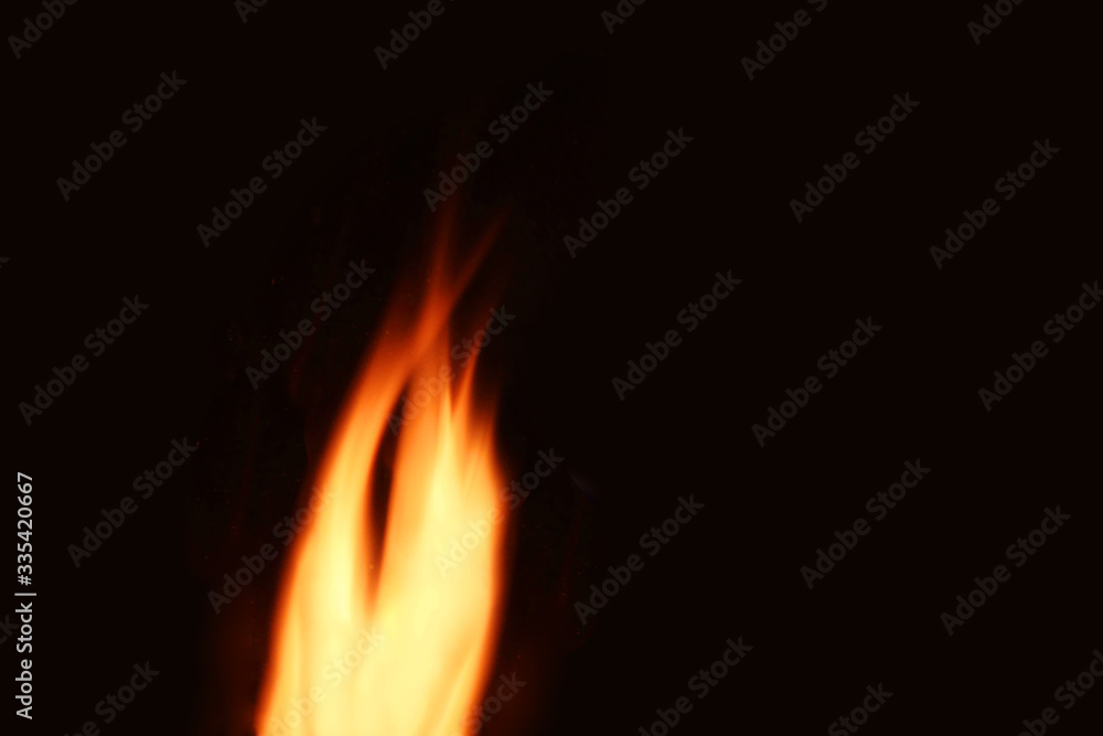 Defocused Background. Fire flame on a black background. Close-up. Defocused Background. Fire flame on a black background. Close-up.