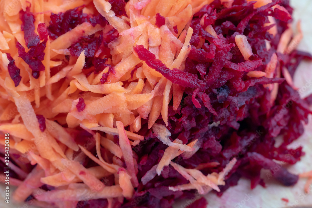 grated fresh vegetables for borscht. Grate the carrots and beets on a fine grater. Health food. grated fresh vegetables for borscht. Grate the carrots and beets on a fine grater. Health food.