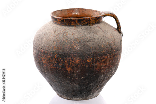 Old handmade clay pitcher isolated on a white background.