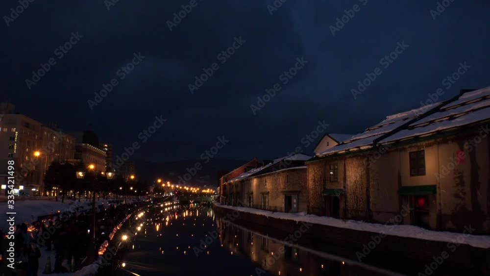 OTARU, HOKKAIDO, JAPAN - FEBRUARY 2020 : Scenery of OTARU CANAL in winter snow season. Popular tourist destination for Japanese and foreign visitors. Historical buildings beside the canal. OTARU, HOKKAIDO, JAPAN - FEBRUARY 2020 : Scenery of OTARU CANAL in winter snow season. Popular tourist destination for Japanese and foreign visitors. Historical buildings beside the canal.