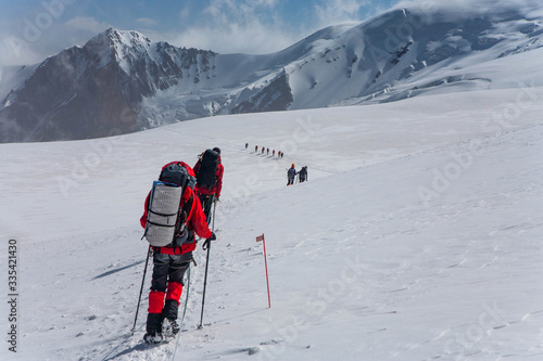Scenic landscape of mountains in Kyrgyzstan. The Trans-Alay Range. Pamir Mountain System. Climbers making the ascent.