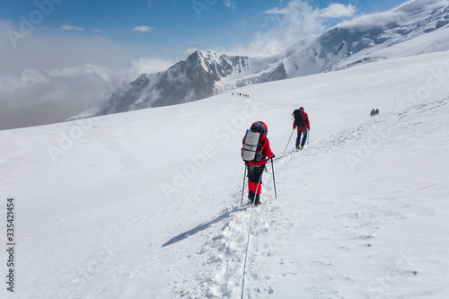 Scenic landscape of mountains in Kyrgyzstan. The Trans-Alay Range. Pamir Mountain System. Climbers making the ascent.