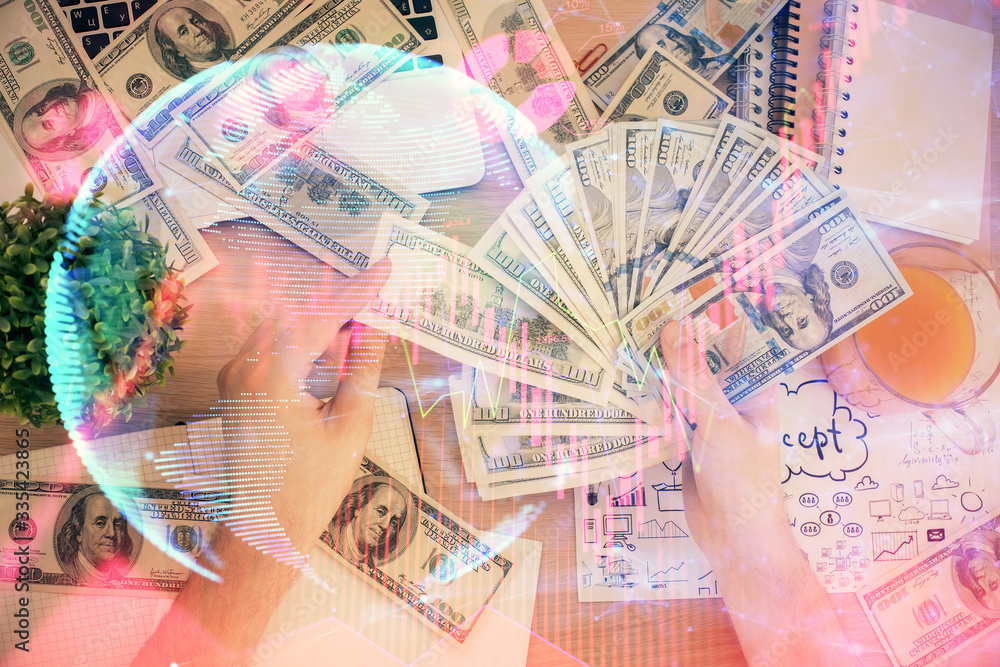 Multi exposure of financial theme drawing hologram and USA dollars bills and man hands. Business concept. Multi exposure of financial theme drawing hologram and USA dollars bills and man hands. Business concept.