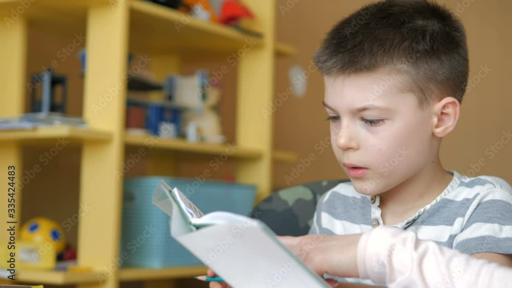 Home schooling. Boy doing his homework at home during the quarantine Home schooling. Boy doing his homework at home during the quarantine