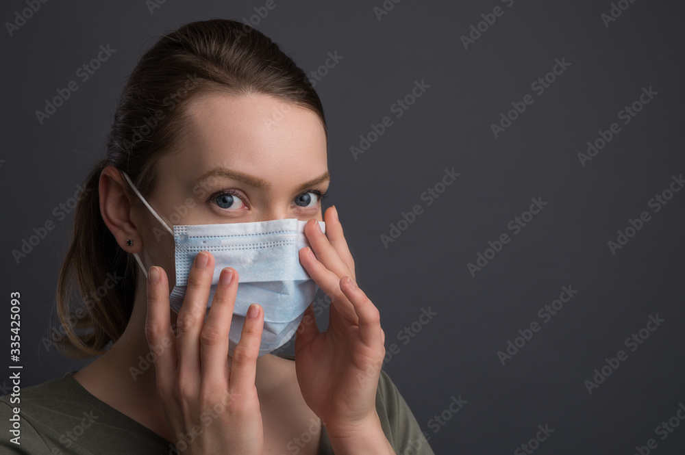 Coronavirus,covid19 girl in a mask on a gray background. The title is about an outbreak of a coronavirus virus in China, an illness. Epidemic and Pandemic: News Headlines and Media Coronavirus,covid19 girl in a mask on a gray background. The title is about an outbreak of a coronavirus virus in China, an illness. Epidemic and Pandemic: News Headlines and Media