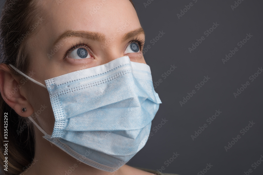 Epidemic and pandemic. Girl in a medical mask on a black background with space for an inscription. Coronavirus Epidemic and pandemic. Girl in a medical mask on a black background with space for an inscription. Coronavirus