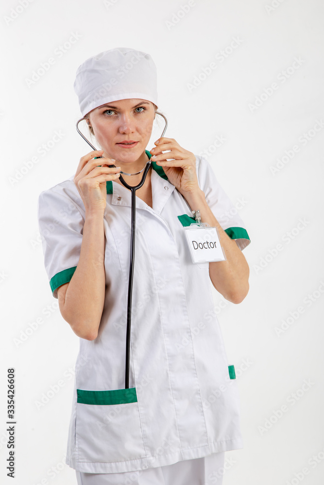 Doctor in a white robe with a stethoscope in his hands. Doctor in a white robe with a stethoscope in his hands.
