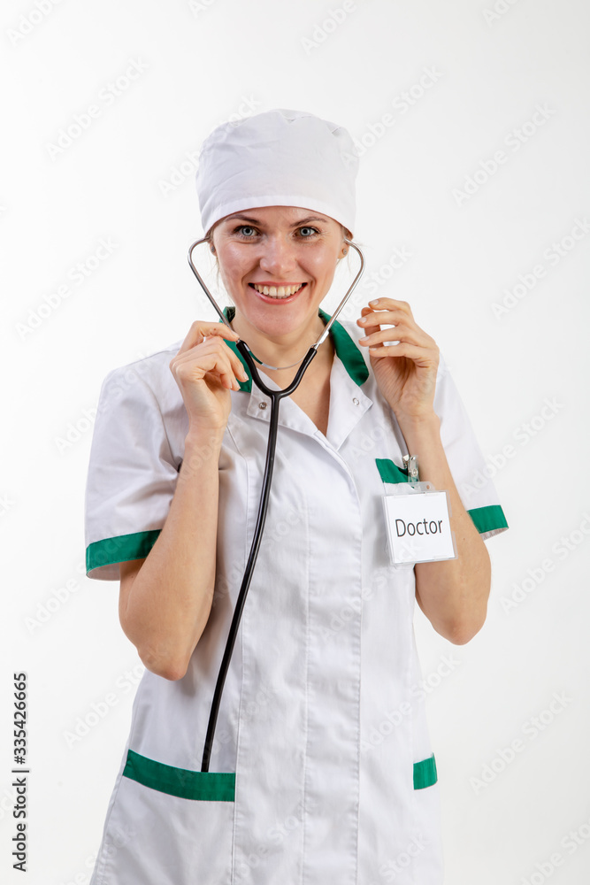 Doctor in a white robe with a stethoscope in his hands. Doctor in a white robe with a stethoscope in his hands.