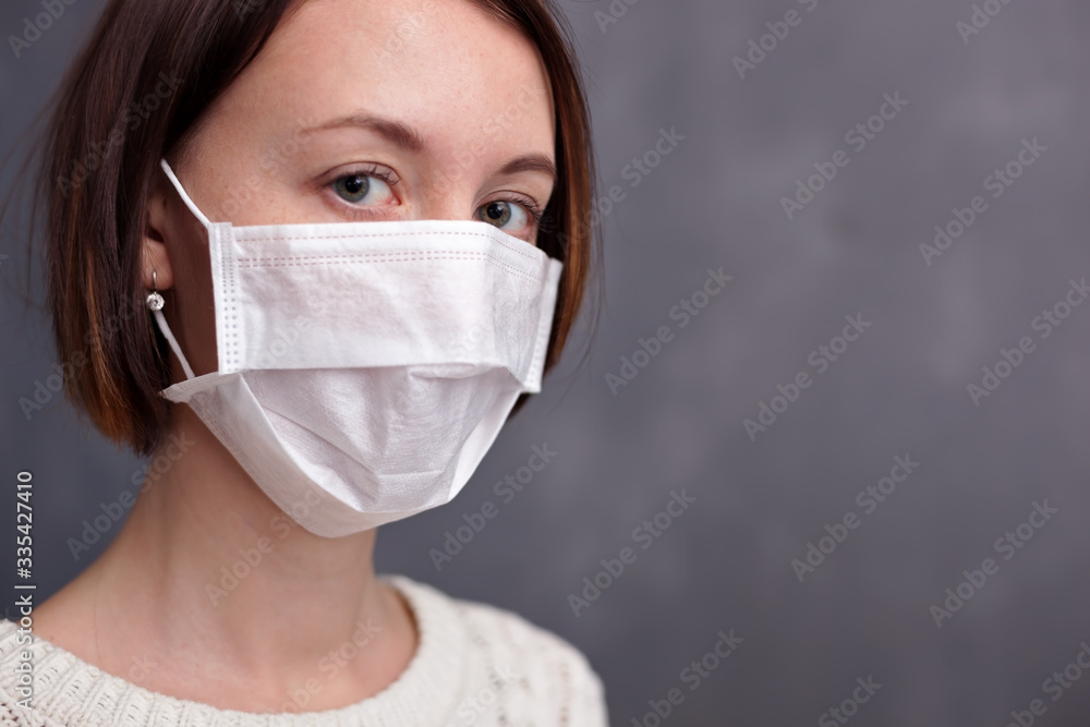 Young caucasian nurse wearing mask looking at camera. Young caucasian nurse wearing mask looking at camera.