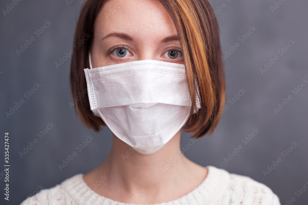 Young caucasian nurse wearing mask looking at camera. Young caucasian nurse wearing mask looking at camera.