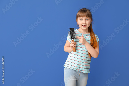 Little girl with hair brush...