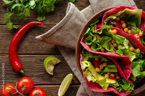 Vegan beetroot taco with salad, avocado, chickpea and
