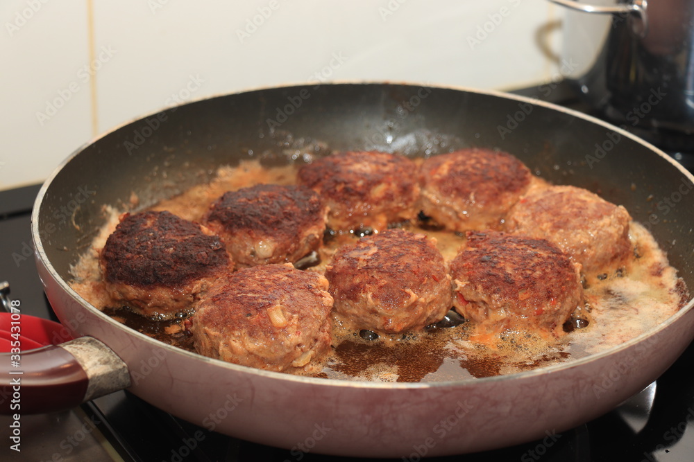 Frying meatballs in pan